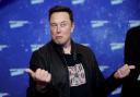SpaceX owner and Tesla CEO Elon Musk gestures as he arrives on the red carpet for the Axel Springer Awards ceremony, in Berlin, 2020