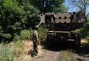 Kuzia, the commander of the unit, shows the rockets on HIMARS vehicle in Eastern Ukraine