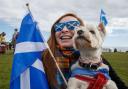 A marcher and her dog during an All Under One Banner march for independence in Arbroath