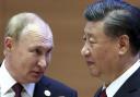 Russian President Vladimir Putin, left, speaks to Chinese President Xi Jinping (Sergei Bobylev, Sputnik, Kremlin Pool Photo via AP).