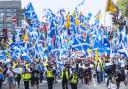 Scottish independence supporters walk through Glasgow during an All Under One Banner march