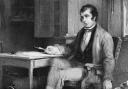 Scots poet Robbie Burns in his cottage composing 'The Cotter's Saturday Night'