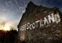 A farm outbuilding has graffiti written on the side of it near to Bannockburn in Stirling