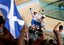 Scotland's Neil Fachie celebrates winning gold with teammate Matt Rotherham as pilot