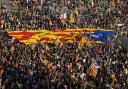 Catalan independence supporters fly the Estelada in Plaza de Espana square in Barcelona
