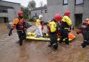 Members of the emergency services help local residents to safety in Brechin, Scotland, as Storm Babet batters the country.