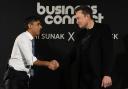 British Prime Minister Rishi Sunak (L) shakes hands with Tesla and SpaceX CEO Elon Musk after an in-conversation event