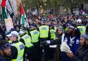 A police line separates members of the Black Hebrew Israelite Movement (right) and Pro-Palestinian supporters at a rally in Trafalgar Square, London