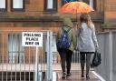 Voters arrive at a polling station in Glasgow