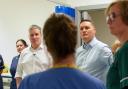Keir Starmer (left) and Wes Streeting talk to NHS workers