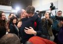 Labour candidate Damien Egan hugs his husband Yossi Felberbaum after being declared MP for Kingswood