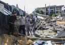 People inspect the damage to their homes following Israeli air strikes on February 20, 2024 in Rafah, Gaza