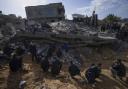 Palestinians check destruction after an Israeli strike in Rafah