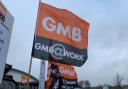 A GMB flag held by a protestor