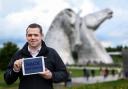 Douglas Ross holds a tablet with the words 'Sack Matheson' during a campaign visit to the Kelpies on Monday