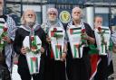Campaigners and charities including Show Israel the Red Card and Scottish Friends of Palestine are pictured holding coffins and flowers outside Hampden stadium