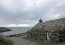 Cottage on the Isle of Lewis with view of the sea in the background
