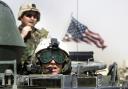 U.S. Army 3rd Infantry Task Force 3-7 soldiers ride atop an armored vehicle during a training exercise near the Iraqi border