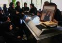 Mourners gather around the coffin of Lebanese journalist Amal Khalil who was killed on Wednesday in an Israeli airstrike, ahead of her funeral procession in the village of Baysariyeh, southern Lebanon