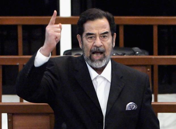 The National: BAGHDAD, IRAQ - NOVEMBER 5:  Former Iraqi President Saddam Hussein shouts as he receives his guilty verdict during his trial in the fortified 'green zone', on November 5, 2006 in Baghdad, Iraq. Hussein was found of guilty over his role in the