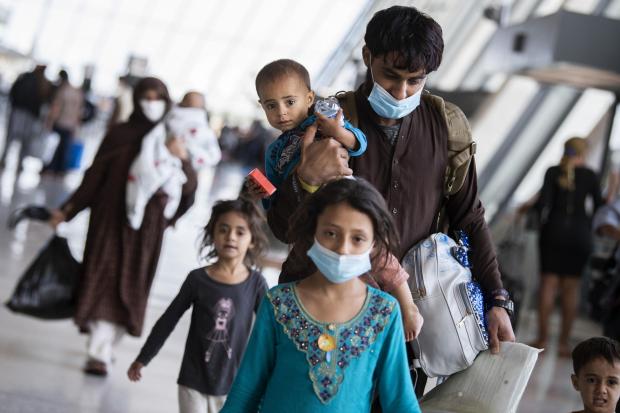 The National: UNITED STATES - AUGUST 27: Afghan refugees arrive to Dulles International Airport on Friday, August 27, 2021, after leaving Afghanistan as it fell to the Taliban. Some evacuees are American citizens or reside in the U.S. and were visiting Afghanistan at