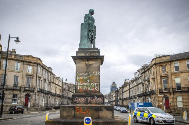 Graffiti that reads 'Son of slaver and Colonialist Profiteer' on the statue of Robert Dundas 2nd Viscount Melville, son of Henry Dundas