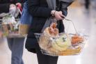 Undated file photo of a woman shopping holding a basket. UK grocery sales have tumbled by 4% over the past three months as shoppers continue to return steadily to pre-pandemic habits, according to figures. Data firm Kantar founded that sales declined for