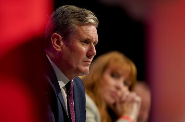 The National: Labour leader Sir Keir Starmer and Labour deputy leader Angela Rayner listen as shadow chancellor Rachel Reeves gives her keynote speech at the Labour Party conference