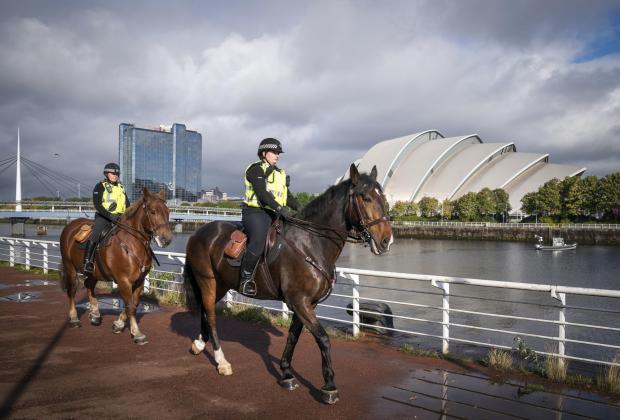 The National: Laura Kinlan (right) riding Inverness and Karen Graham riding Montrose alongside the River Clyde near the COP26 venues as Police Scotland counter terrorism announce a Project Servator campaign ahead of the international climate conference, being held in