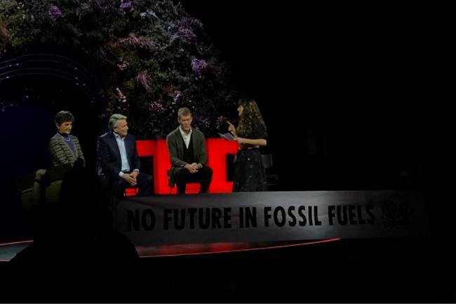 Climate activist Lauren (far right) takes Shell CEO Ben van Beurden (second from left) to task over Cambo oil field and climate impact.