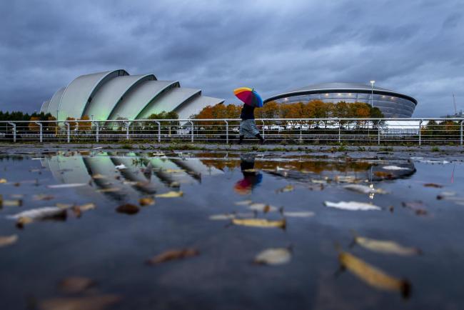 United Nations COP26 climate change conference preparation. Pictured are the Armadillo, left and OVO Hydro, both part of the SEC campus in Glasgow where COP 26 is taking place are reflected in a leaf strewn puddle.  COP 26 starts on 31st October and