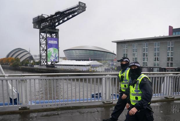 The National: Police officers walk passed the Scottish Event Campus in Glasgow where Cop26 is being held. Picture date: Friday October 29, 2021. PA Photo. Photo credit should read: Andrew Milligan/PA Wire.