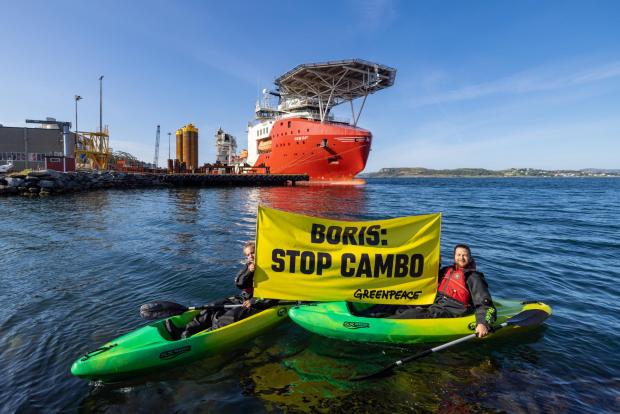 The National: Greenpeace Norway activists in kayaks confront Siem Day loading drilling infrastructure for the Cambo oil field on behalf of Siccar Point Energy and Shell Oil, at Randaberg Industries, outside Stavanger, Norway..