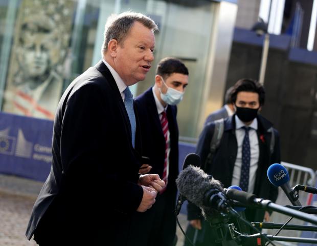 The National: The UK's chief Brexit negotiator David Frost speaks with the media outside EU headquarters in Brussels.