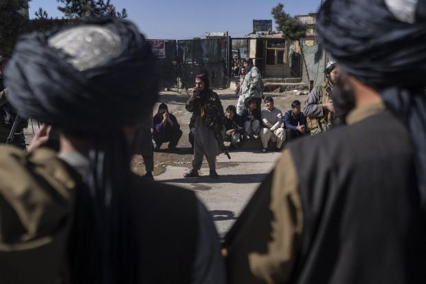 The National: Taliban fighters secure the area after a roadside bomb went off in Kabul Afghanistan, Monday Nov. 15, 2021. The bomb exploded on a busy avenue in the Afghan capital on Monday, wounding two people, police said. (AP Photo/ Petros Giannakouris).