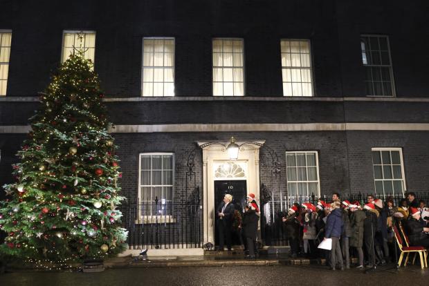 The National: Johnson outside of Downing Street turning on Christmas lights