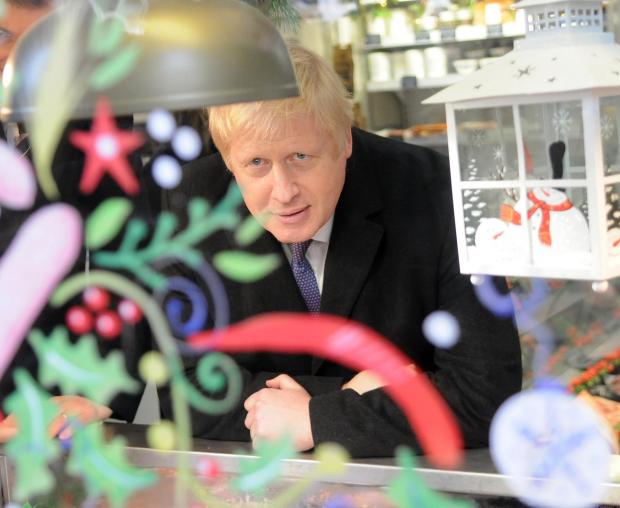 The National: Boris Johnson in Pritchett Family Butchers..Prime Minister Boris Johnson visits Salisbury Christmas Fair in the Guildhall Square, Salisbury DC9338P18 Picture by Tom Gregory.
