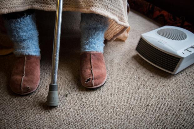 The National: BRISTOL, ENGLAND - FEBRUARY 16:  In this photo illustration an elderly person sits in a chair at home on February 16, 2015 near Bristol, England. The issues affecting the elderly, along with education and the economy are likely to be key elections issues