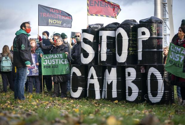 The National: Activists from Friends of the Earth during a demonstration calling for an end to all new oil and gas projects in the North Sea, starting with the proposed Cambo oil field, outside the UK Government's Cop26 hub during the Cop26 summit in Glasgow.