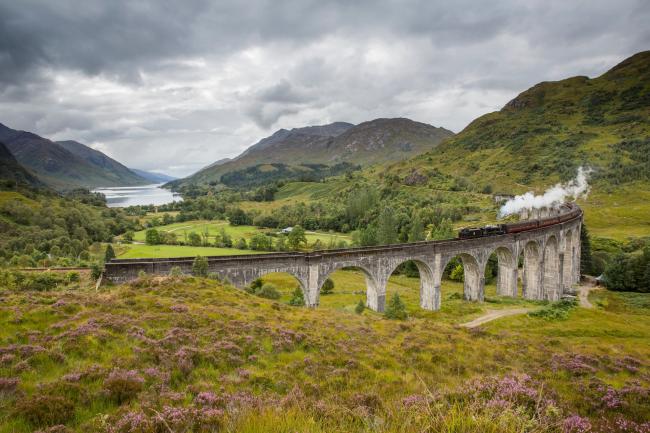 The Jacobite steam train passing over the Glenfinnan Viaduct at the head of Loch Shiel, Lochaber, Highlands of Scotland.