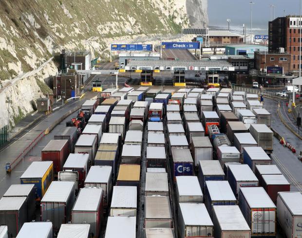 The National: Lorries queue to enter the port of Dover in Kent. Christmas stockpiling and Brexit uncertainty have again caused huge queues of lorries to stack up in Kent. The latest delays came as the UK marked less than two weeks until 2021 and the end of the Brexit