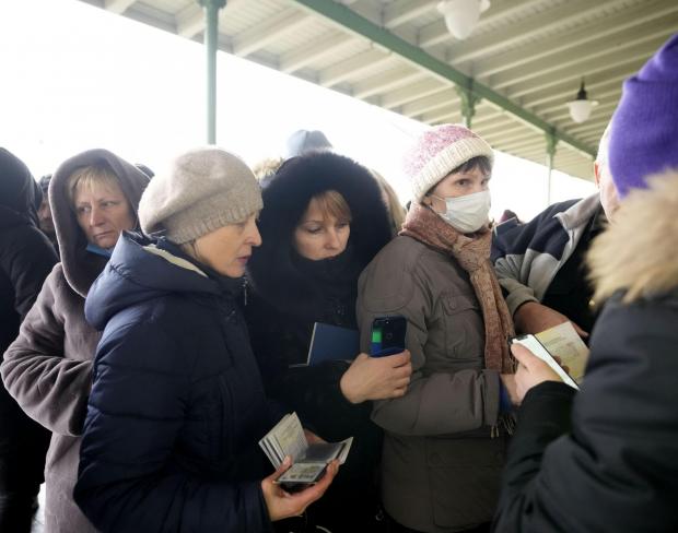 The National: People, fleeing Ukraine, register for a bus which will take them to Germany, at the train station in Przemysl, Poland, Friday, March 4, 2022. More than 1 million people have fled Ukraine following Russia's invasion in the swiftest refugee exodus in this