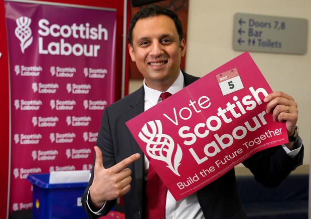 The National: Scottish Labour leader Anas Sarwar holds a poster showing the new Scottish Labour logo during the Scottish Labour conference at Glasgow Royal Concert Hall. Picture date: Friday March 4, 2022. PA Photo. See PA story POLITICS ScotLabour. Photo credit
