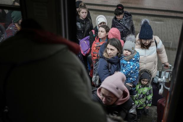 The National: CHOP, UKRAINE - MARCH 16: People fleeing Ukraine board a humanitarian train organised by the Slovak Rail Company (ZSSK) to bring refugees from Ukraine to Kosice, Slovakia on March 16, 2022 in Chop, Ukraine. The humanitarian train departs Slovakia twice a