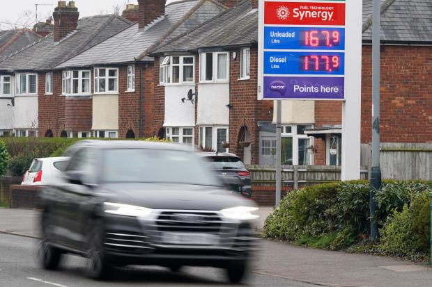 The National: A display sign showing unleaded petrol prices at 167.9 per litre and diesel prices at 177.9 per litre at a Esso petrol station in Warwick. Drivers continue to be clobbered by record fuel prices as petrol reaches an average of Â£1.65 per