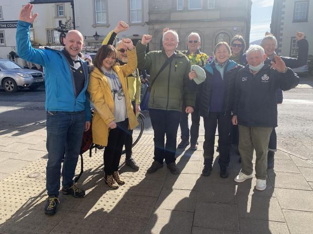 The National: Marshall Douglas, SNP candidate for Tweeddale East, with SNP activists on Peebles High St