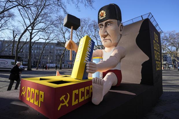A satirical float in Cologne, Germany depicts Vladimir Putin playing with the Ukraine to restore the Soviet Union. Picture: AP Photo/Marin Meissner