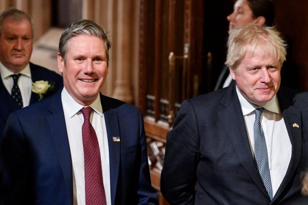 Prime Minister Boris Johnson (right) with the leader of the Labour Party Keir Starmer walk through the Members' Lobby at the Palace of Westminster after the State Opening of Parliament in the House of Lords. Picture: Toby Melville/PA Wire