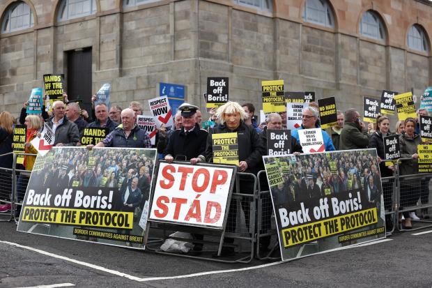 The National: Protestors outside of Stormont waiting for Boris Johnson on Monday