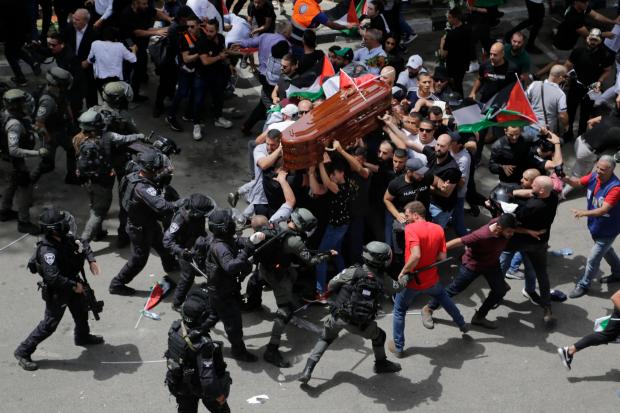 The National: Israeli police confront mourners as they carry Abu Akleh’s coffin (Maya Levin/AP)